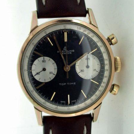 1960's Top Time Geneve Chronograph. Collectible Two Register Black Dial Top Time with White Outer Tachymeter Rim. Mint Condition. Original Breitling Signed Winding Crown and Breitling Strap.
