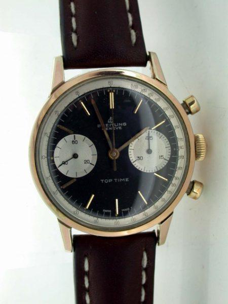 1960's Top Time Geneve Chronograph. Collectible Two Register Black Dial Top Time with White Outer Tachymeter Rim. Mint Condition. Original Breitling Signed Winding Crown and Breitling Strap.