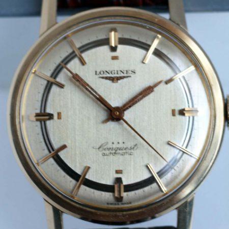 c1950 18k Gold Capped Steel Conquest Automatic in Near NOS Condition with Original Stepped Dial and Beautiful Fish Logo Case-Back and NOS Longines Strap and Buckle